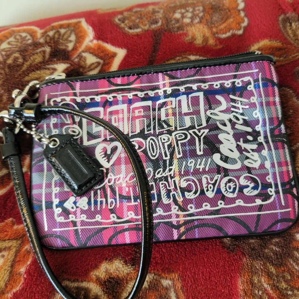 Coach Poppy tartan wristlet in pink and purple.